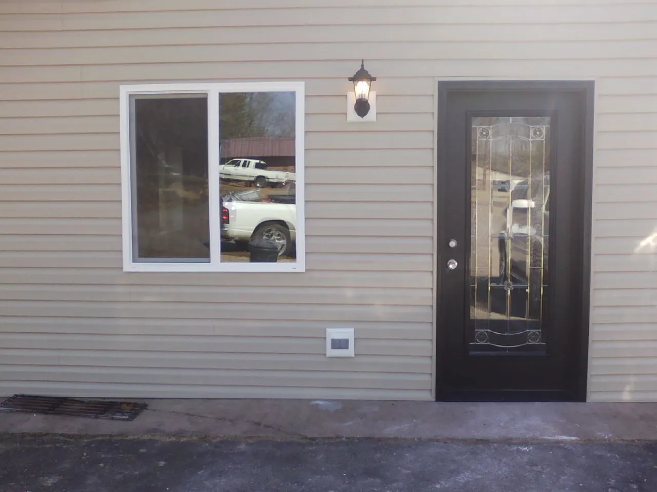 New siding, window and entry door on the side of an addition in Guthrie